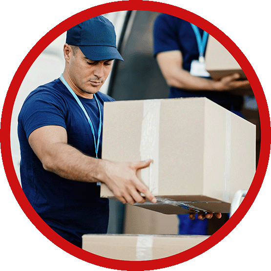 A worker in uniform, carrying a box