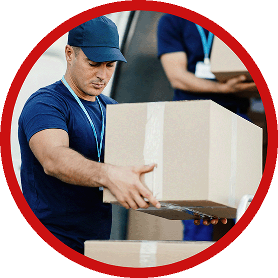 A worker in uniform, carrying a box